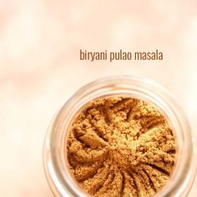 biryani masala powder in a glass jar with text layover.