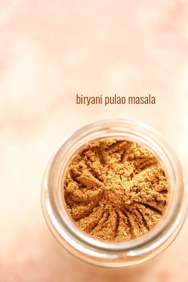 biryani masala powder in a glass jar with text layover.