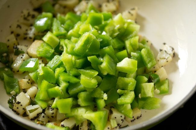 adding capsicum to pan