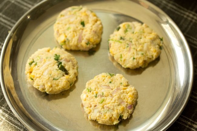 vada mixture flattened and kept on a steel plate