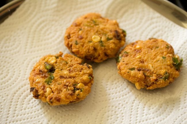 fried chana dal vada on kitchen paper towels