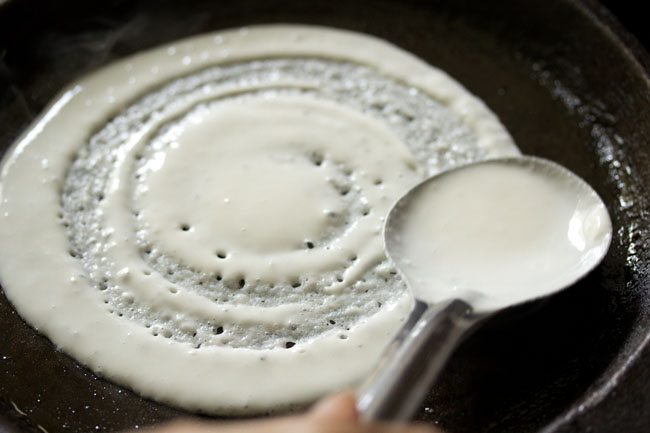 spreading dosa batter for cheese dosa recipe