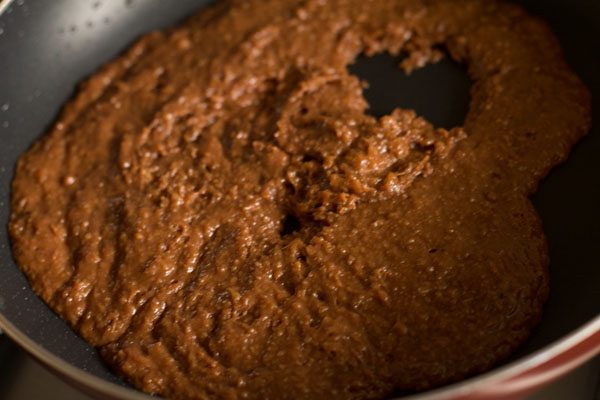 stirring and cooking chocolate modak mixture in the pan