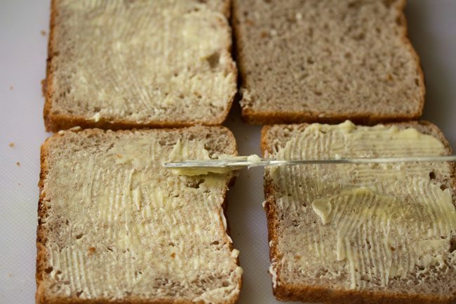 applying butter on bread slices