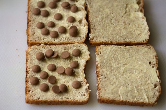 chocolate chips placed on buttered bread slices