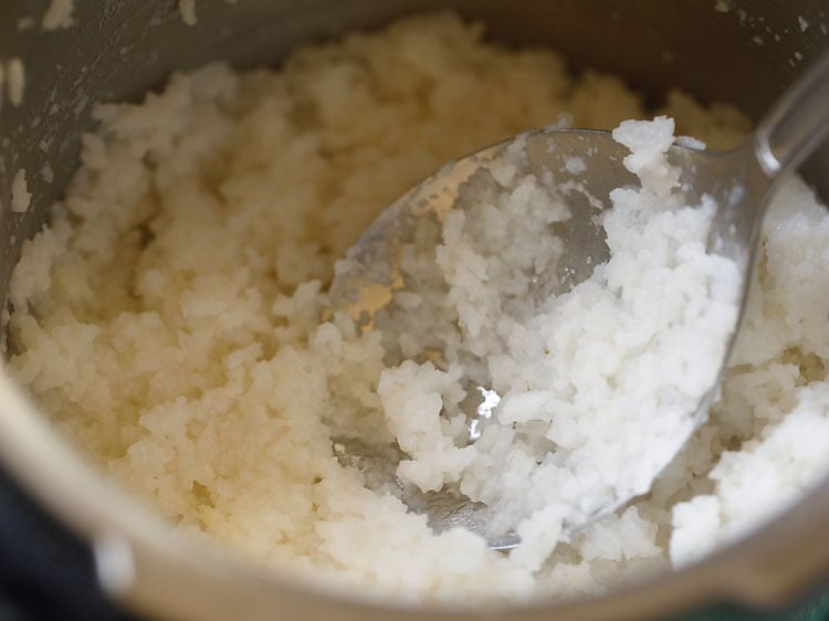 rice being mashed with a spoon. 