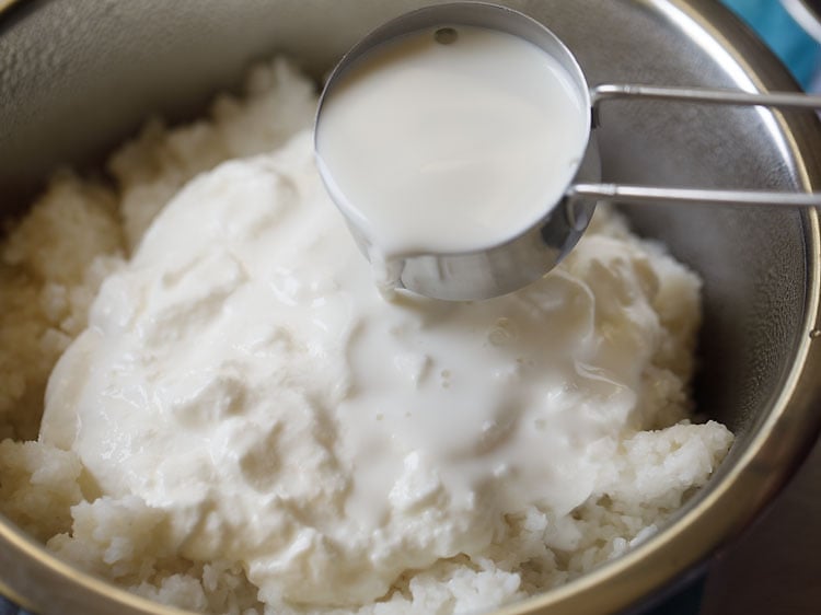 adding milk to the mashed rice. 