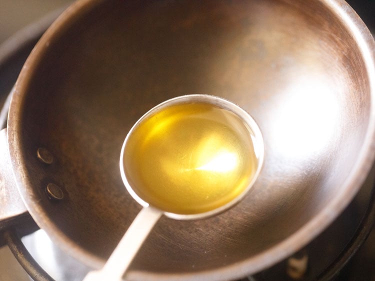 sesame oil (gingelly oil) being added in a small tadka pan