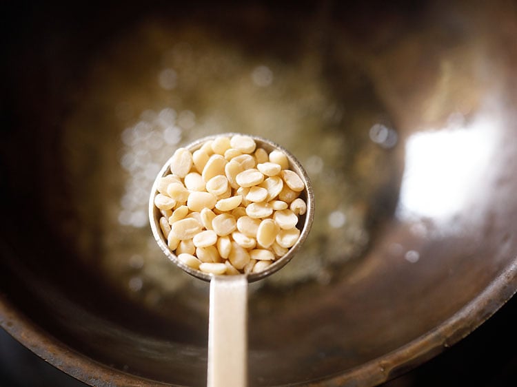 adding urad dal in the hot sesame oil.