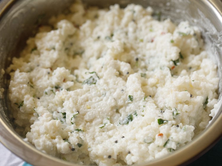 mixing tempering in the curd rice mixture. 