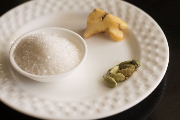 ginger sugar and green cardamom on a white plate