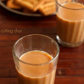 cutting chai served in glasses along with biscuits.