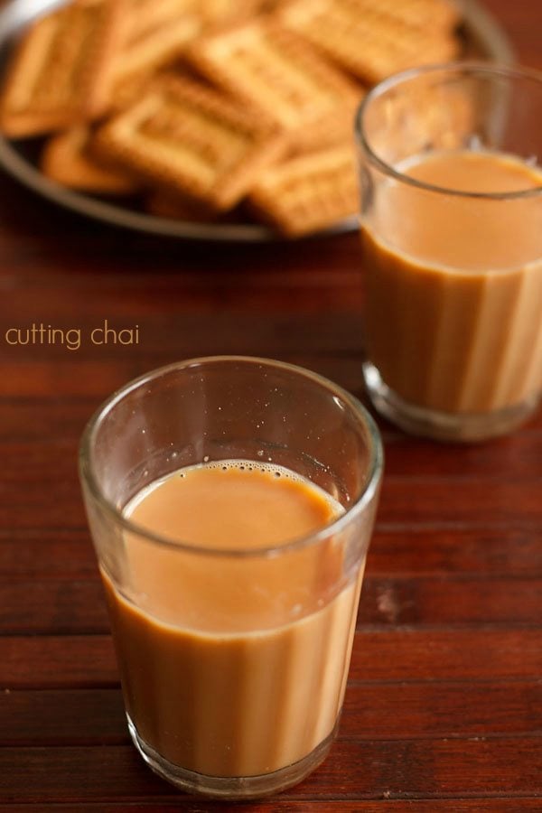 cutting chai served in glasses along with biscuits.