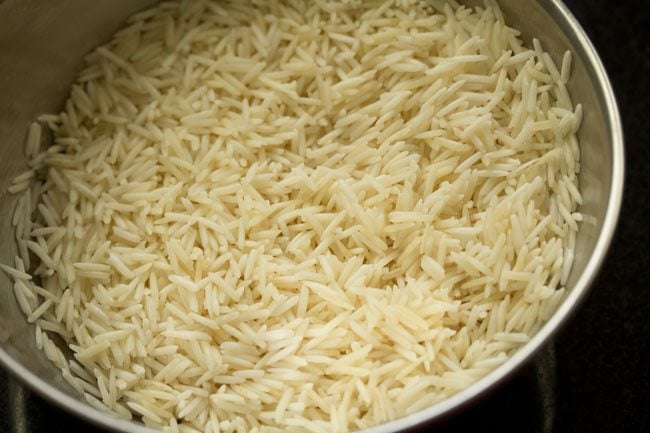 drained rice in steel bowl