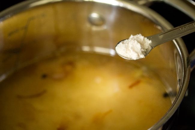 salt being added with a measuring spoon