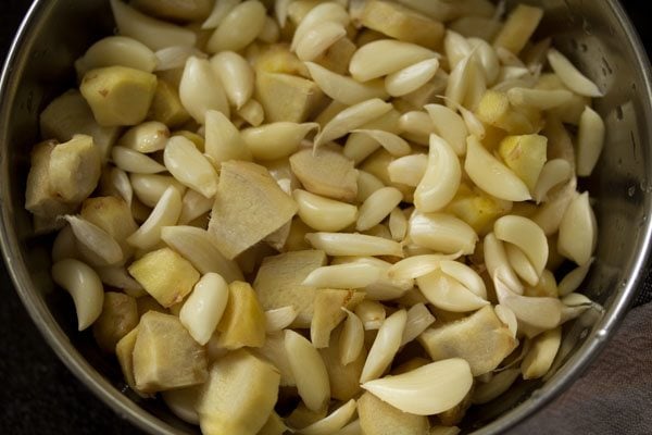 ginger and garlic in a mixie jar for making ginger garlic paste recipe.