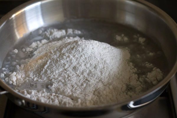 rice flour added to boiling water in the pan. 