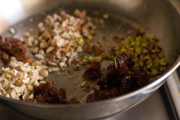 finely chopped dry fruits and chironji added to the hot ghee in pan. 