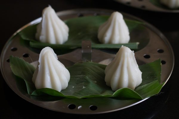 shaped modaks placed on turmeric leaves. 