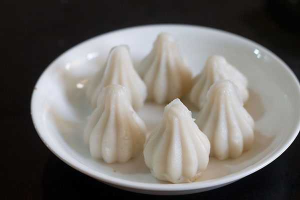 steamed dry fruit modaks on a white plate. 