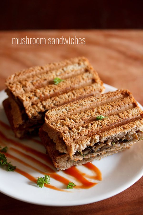 mushroom sandwich on a white plate with ketchup.