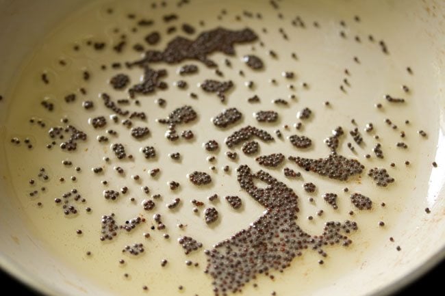 oil and mustard seeds in a pan