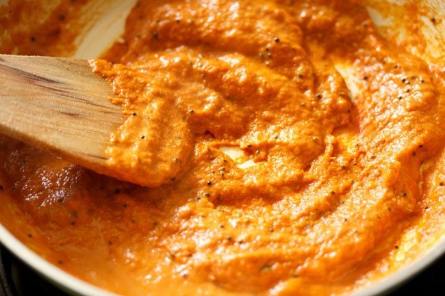 a mixture of chutney and tempering ingredients in a pan