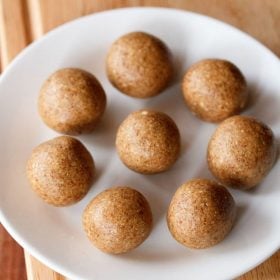 peanut ladoo served on a white plate with text layovers.