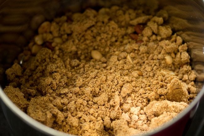 jaggery powder added to the roasted peanuts in the grinder jar. 