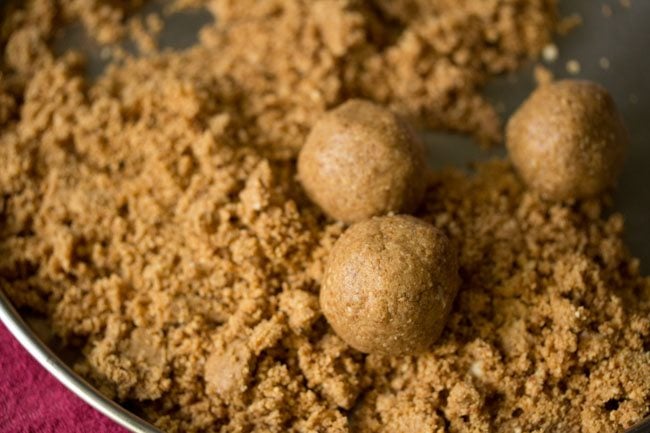 making peanut ladoos with the prepared mixture. 