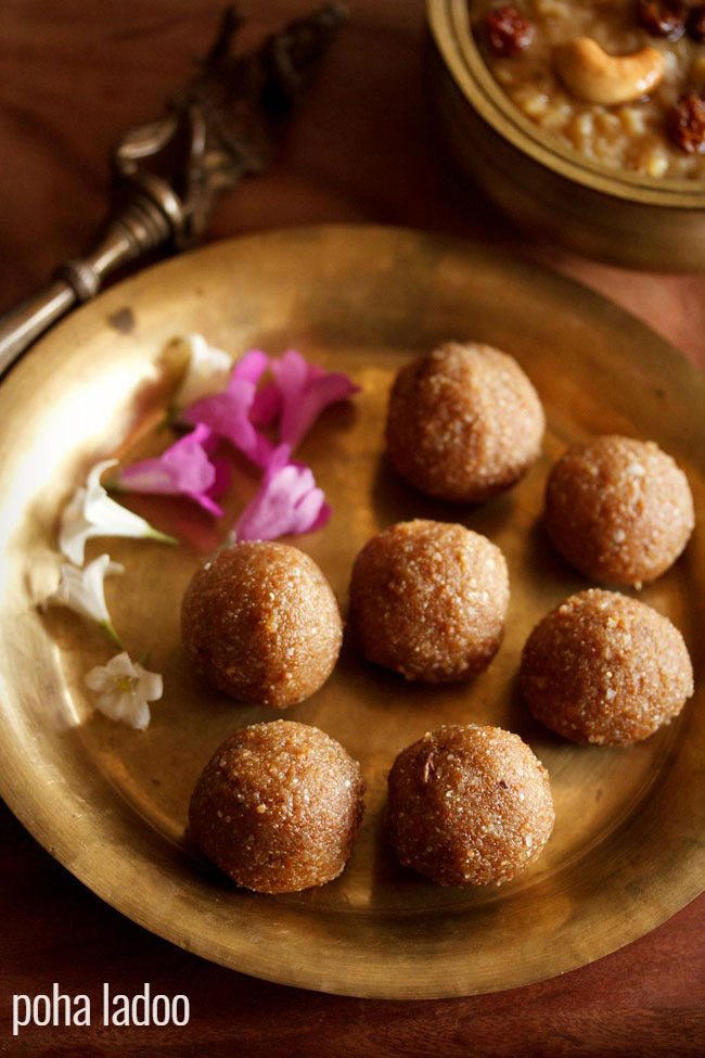 Aval laddu is served in a brass plate with some flowers and text layovers on the side.