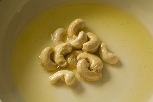 frying cashews in hot ghee. 