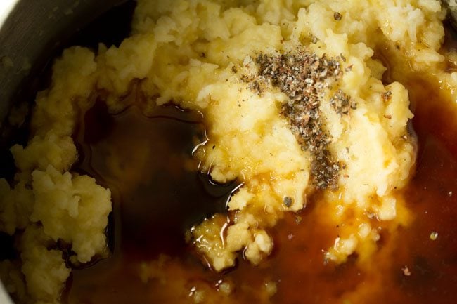 jaggery syrup, cardamom and clove powder on top of mashed rice and lentils