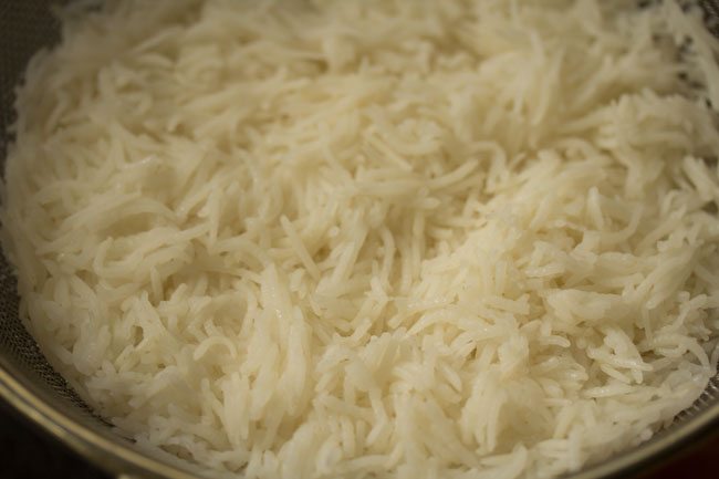 straining the cooked rice. 