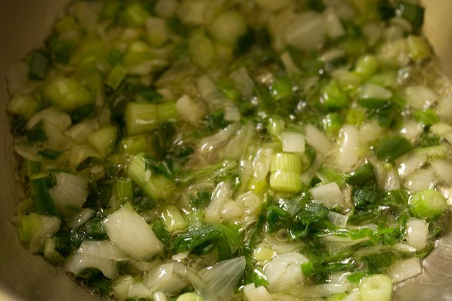 stir frying spring onion whites and greens in hot oil. 