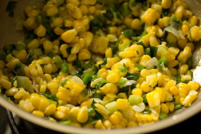 stir frying corn kernels with the rest of the ingredients in the wok. 