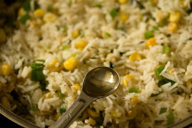 adding rice vinegar to the corn fried rice. 