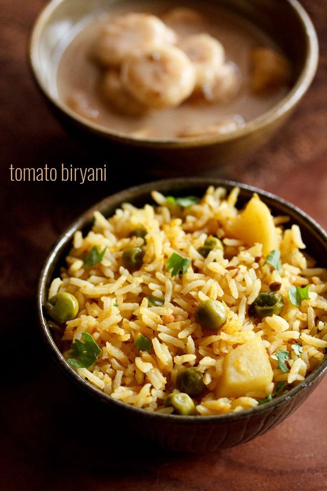 tomato biryani served in a bowl with text layover.