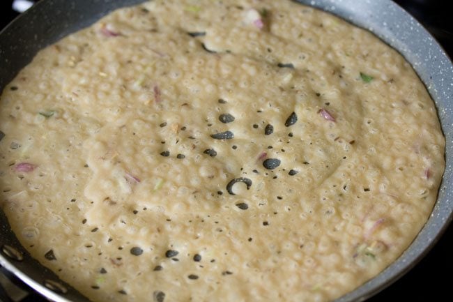 cooking wheat dosa on the pan