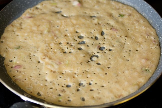 cooking wheat dosa on the pan