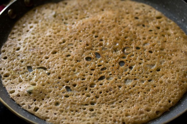 cooked wheat dosa on the pan