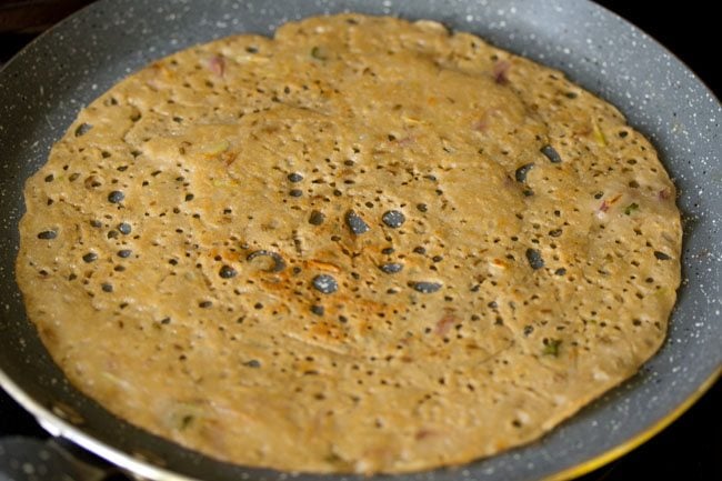 cooked wheat dosa on the pan