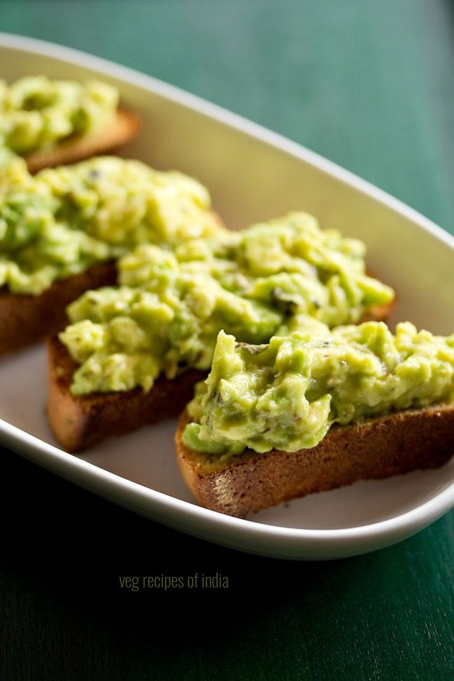 close up shot of a avocado toast in a white tray