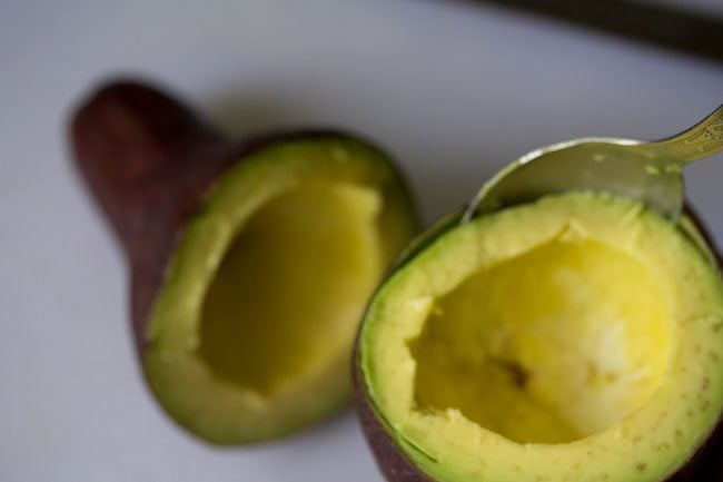 removing avocado pulp with a spoon