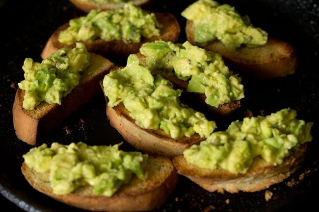 prepared avocado garlic toast slices on skillet