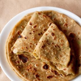 broccoli paratha served on a white plate.