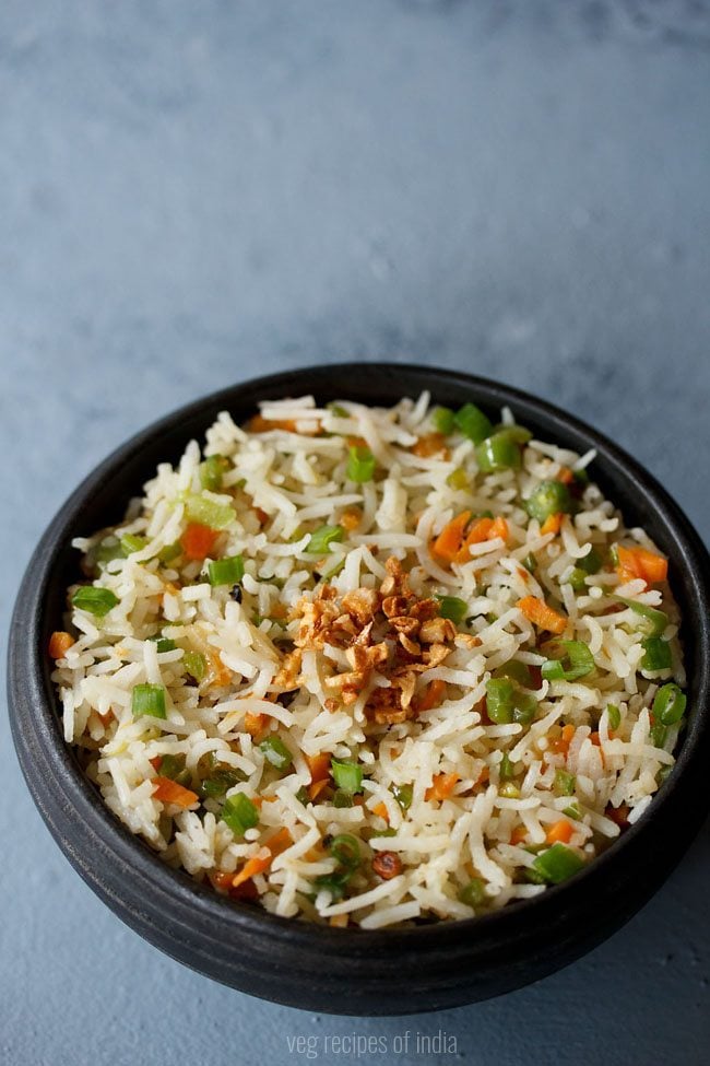 burnt garlic fried rice served in a black bowl