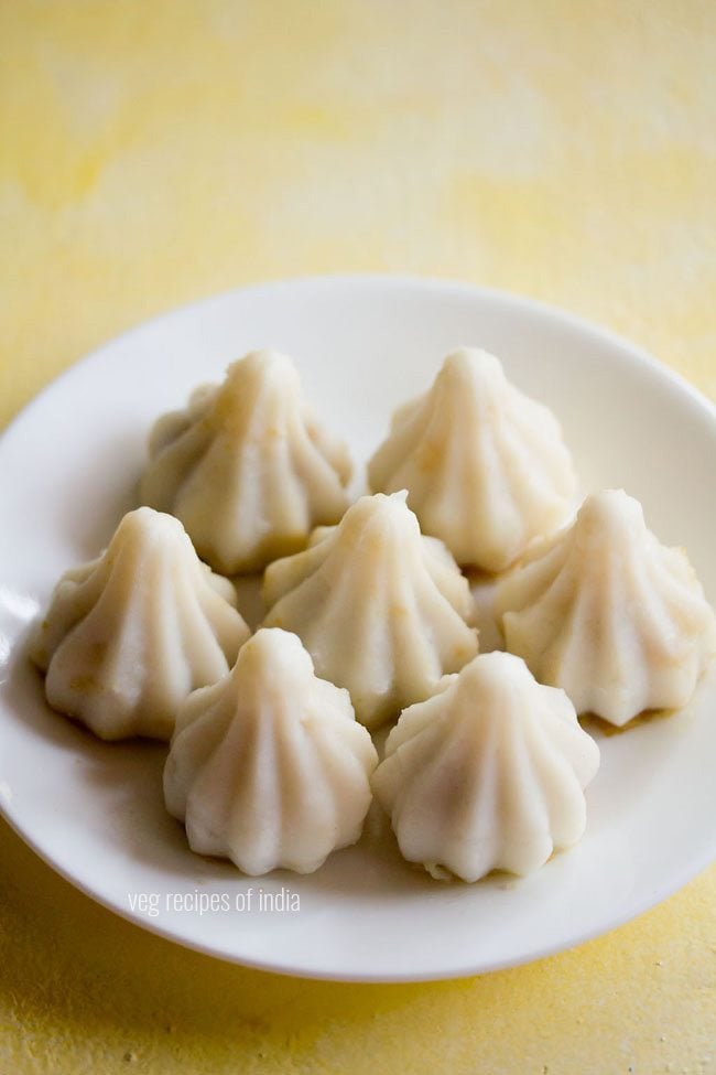 sweet kozhukattai served on a white plate with text layover. 