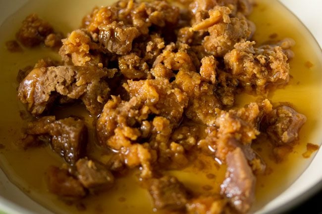 chopped jaggery and water added to a pan for chana dal modak. 