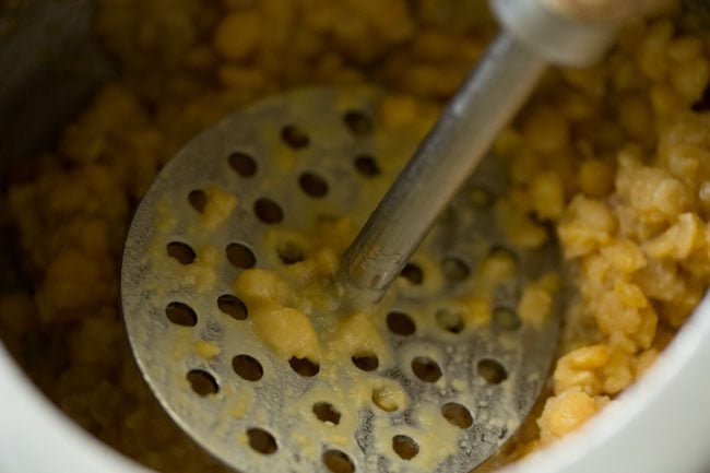 mashing pressure cooked chana dal. 